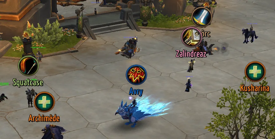 Nameplates of nearby players with round class icons above their names, the healer icon in green.